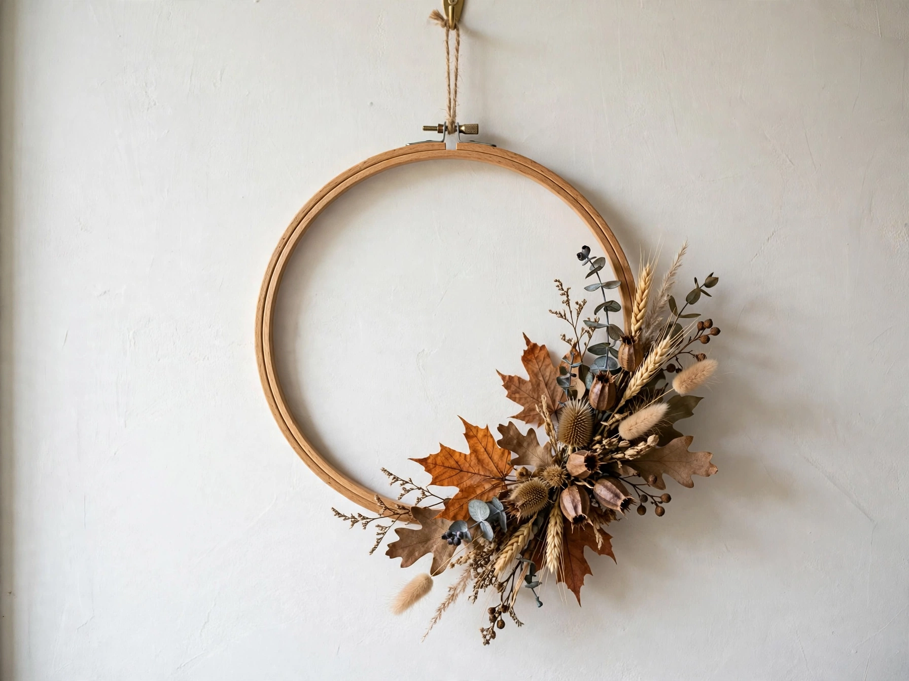 Modern embroidery hoop wreath with autumn leaves on one side