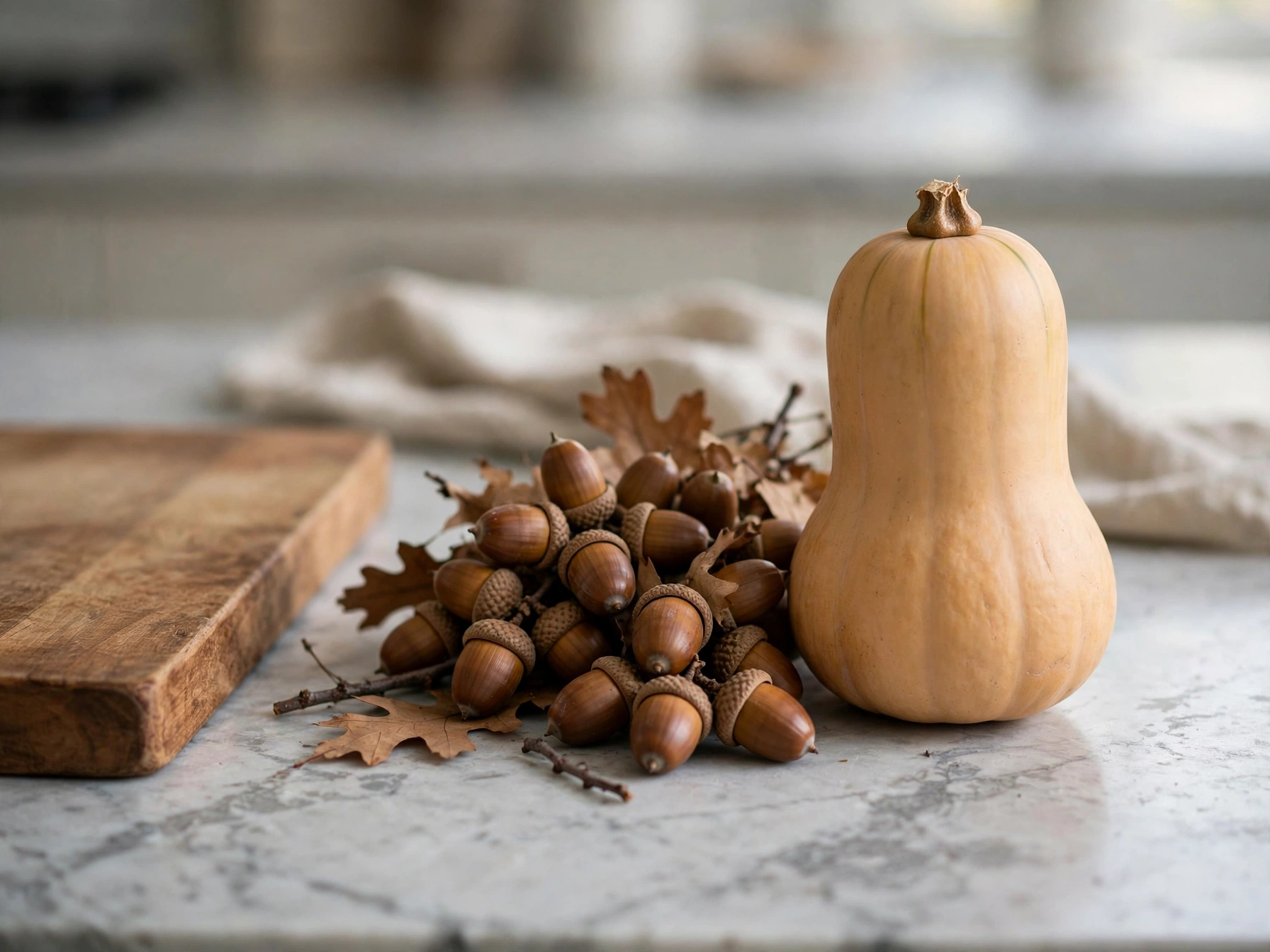 Acorn and butternut squash grouped on a kitchen counter