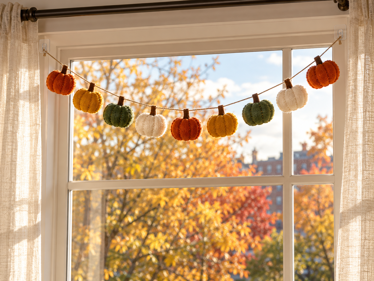 Felt pumpkin garland in autumn light